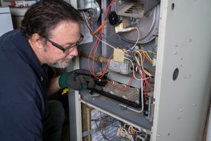 Technician inspecting a furnace