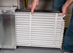 Person replacing their furnace filter