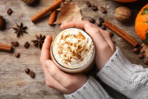 Hands holding a pumpkin spice latte