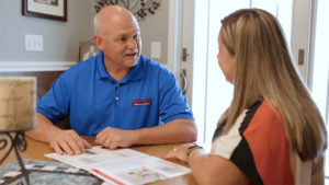 HVAC technician consulting a client