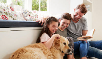 Family at home with pet dog